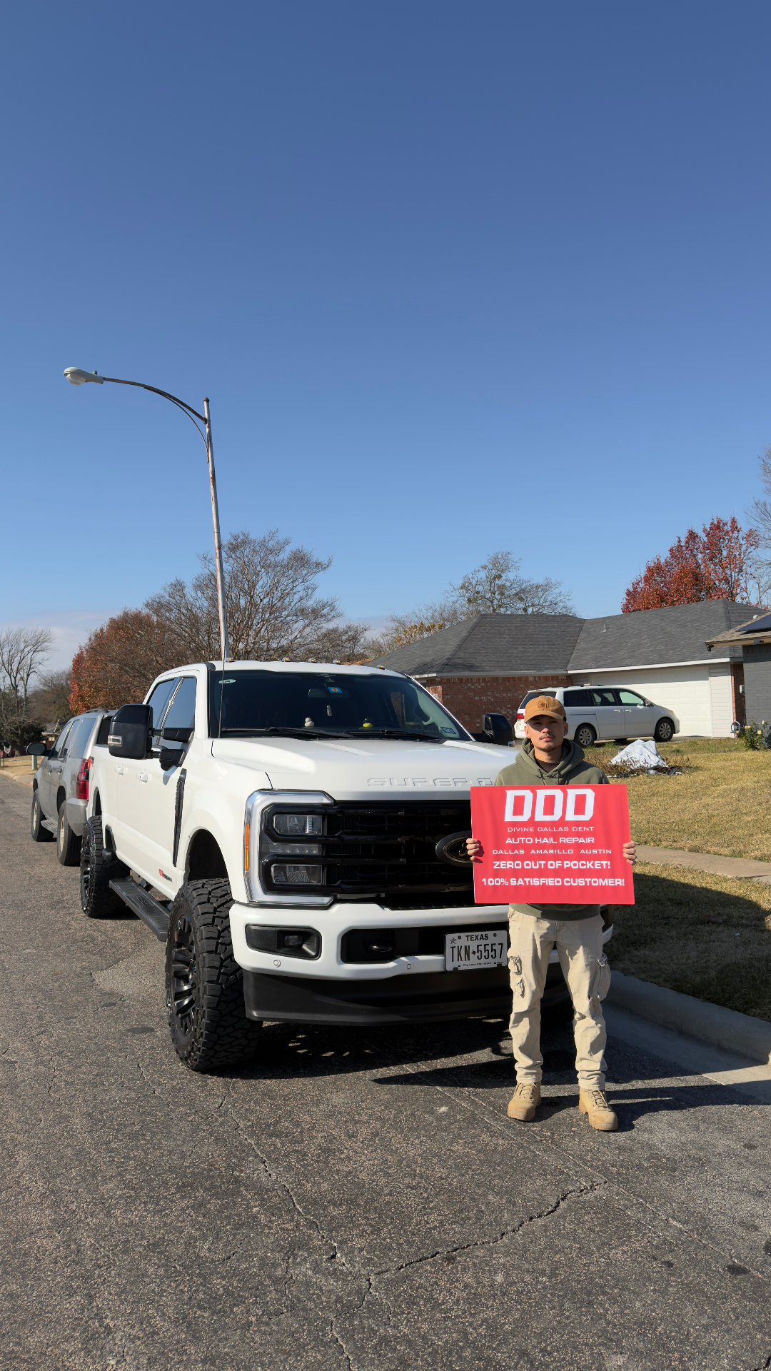 Divine Dallas Dent customer with restored truck after hail repair